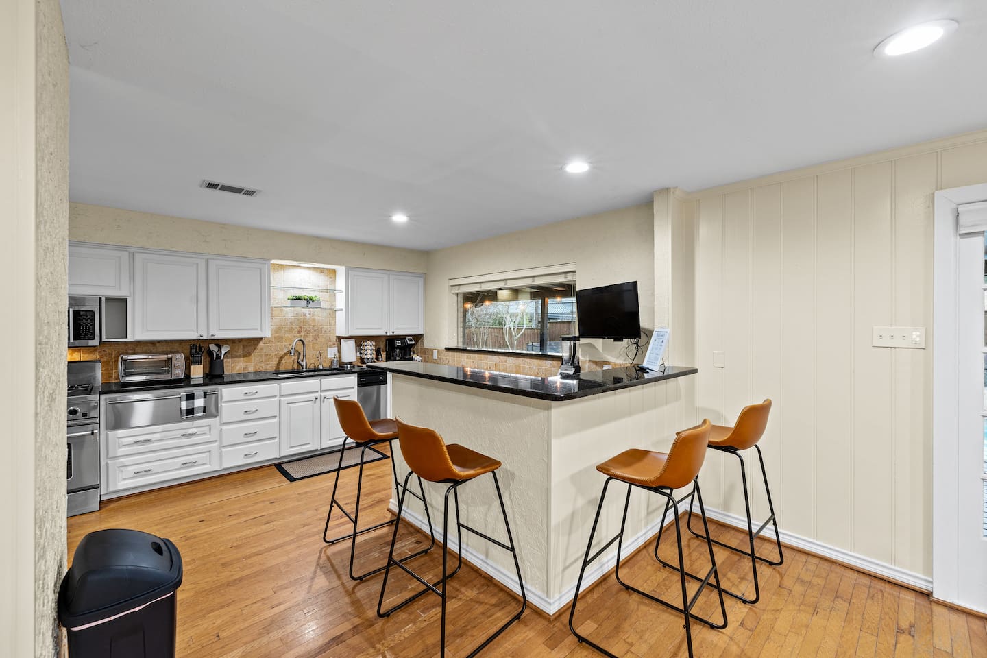 A chef's paradise! A fully stocked kitchen, with a TV, a dedicated ice-maker, and a beautiful view of the backyard! There are four barstools to keep conversation flowing while meals are prepared and memories are made.