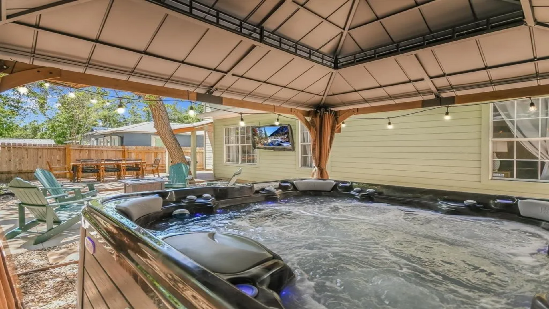 Dive into relaxation in our 7-person hot tub under a stylish gazebo, complete with a TV for ultimate entertainment. With twinkling lights and comfortable seating nearby, it's the perfect spot