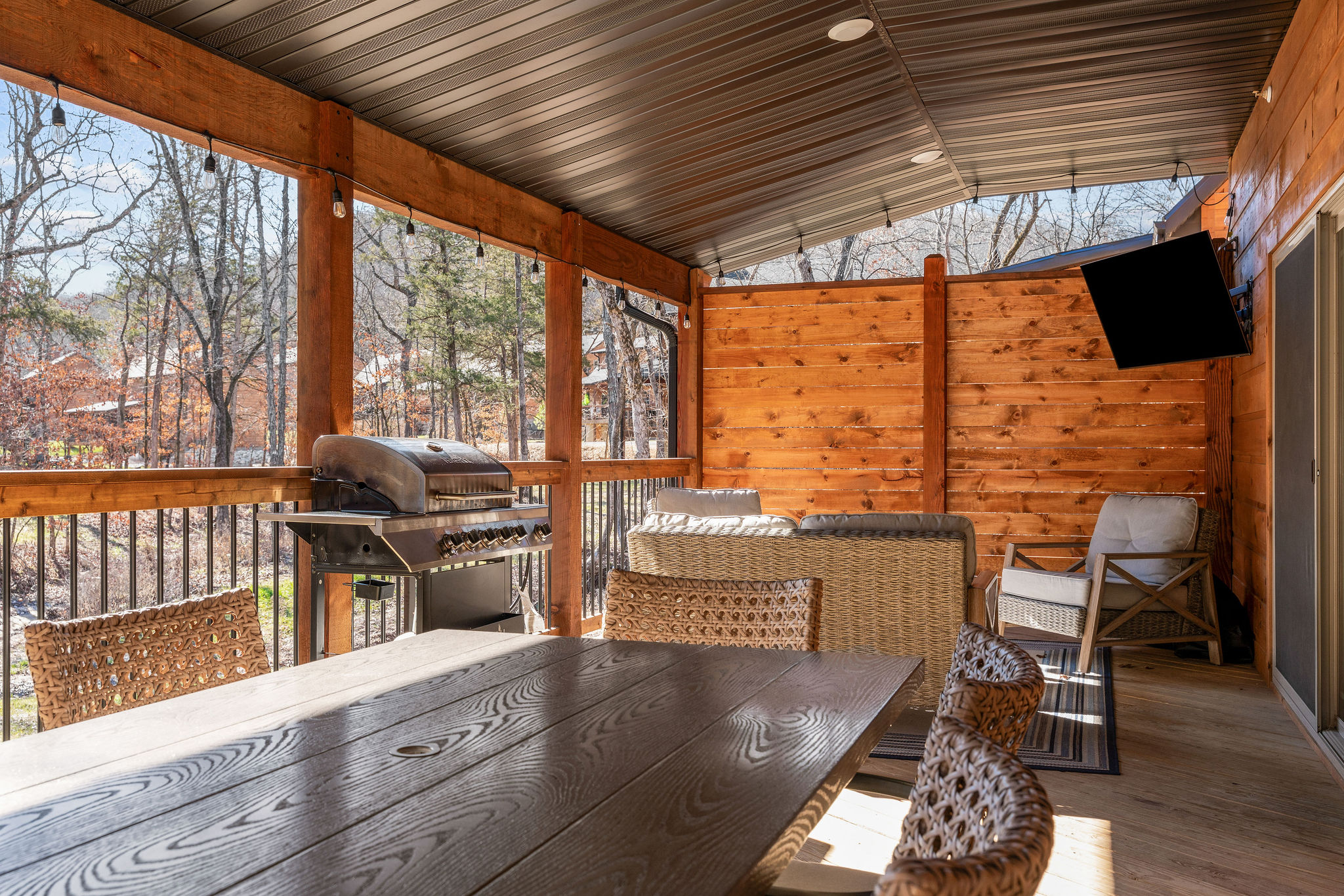 Large priviate outdoor dining space and a TV for relaxed outdoor living.