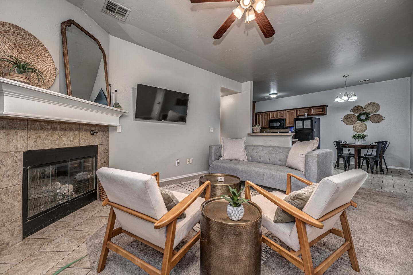Spacious living area featuring comfortable seating, smart TV, and a warm fireplace.