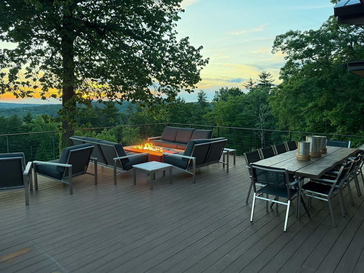 Deck dining and gathering at Sunset Falls &mdash; open-air table with valley views, Berkshires