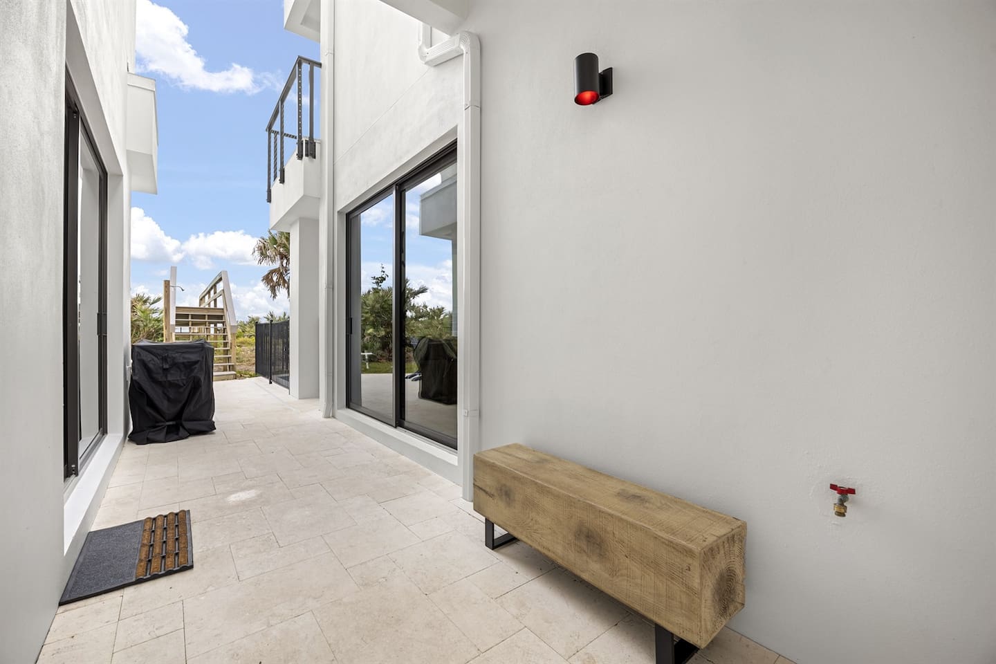 Relax in the serene outdoor space featuring elegant flooring, sliding doors that lead to a charming bridge, creating a peaceful retreat with seamless indoor-outdoor flow, perfect for unwinding and enjoying the surroundings