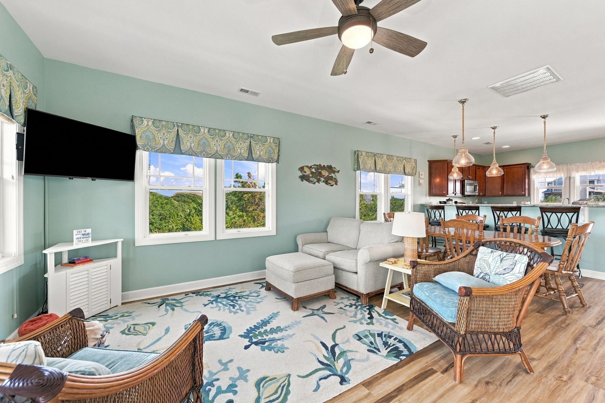 An inviting open-concept layout seamlessly connects the living room, dining area, and kitchen