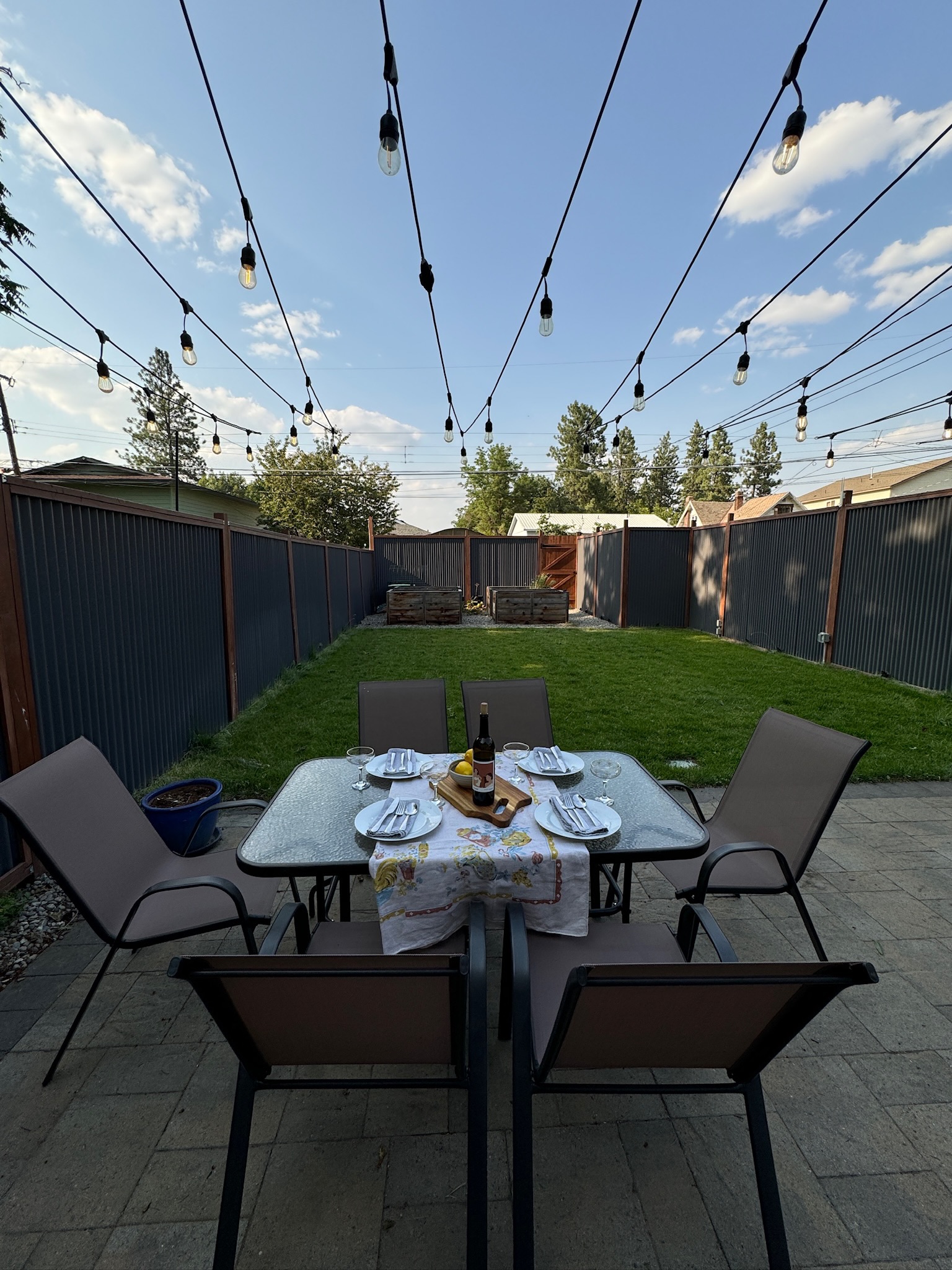 Enjoy dining outdoors on the patio in the fully fenced backyard. Then soak in the hot tub for maximum relaxation!

Guests are encouraged to create their own patio dining experience! Please note: the photographed wine is not included in your stay :) 