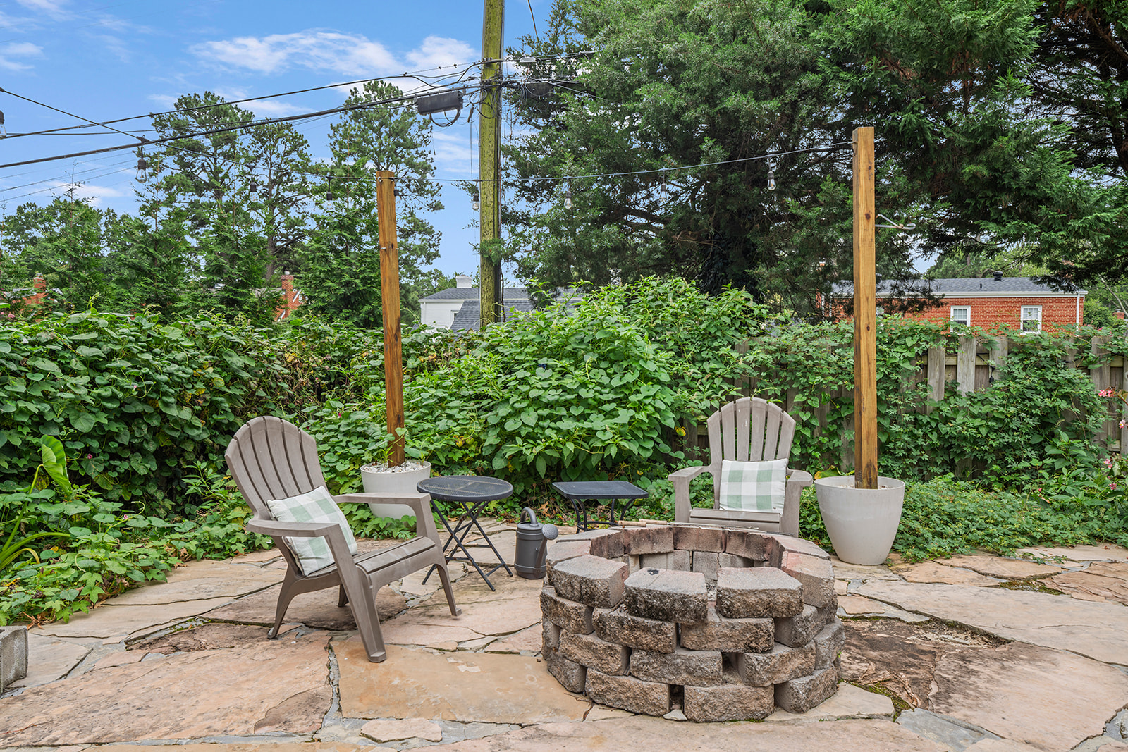 Patio Retreat: Enjoy evenings by the fire pit surrounded by lush greenery and twinkling lights!