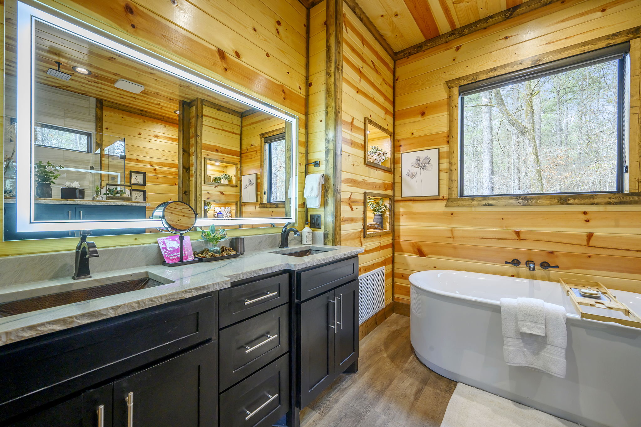 This spacious ensuite features a walk-in shower, soaking tub, and high-end finishes