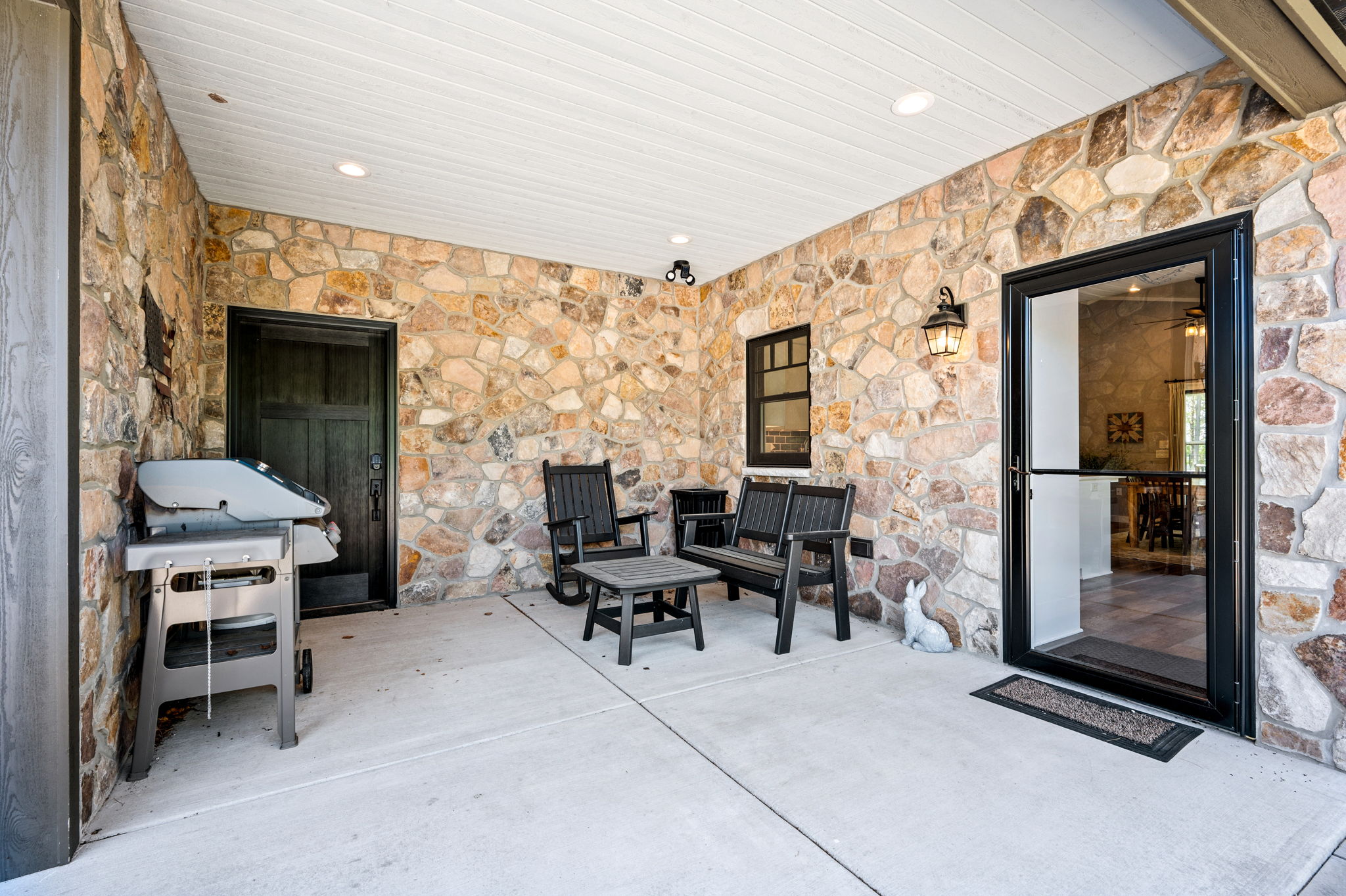 Grill out and relax on the covered stone patio, complete with a gas grill, rocking chairs, and a screen door leading straight to the kitchen.