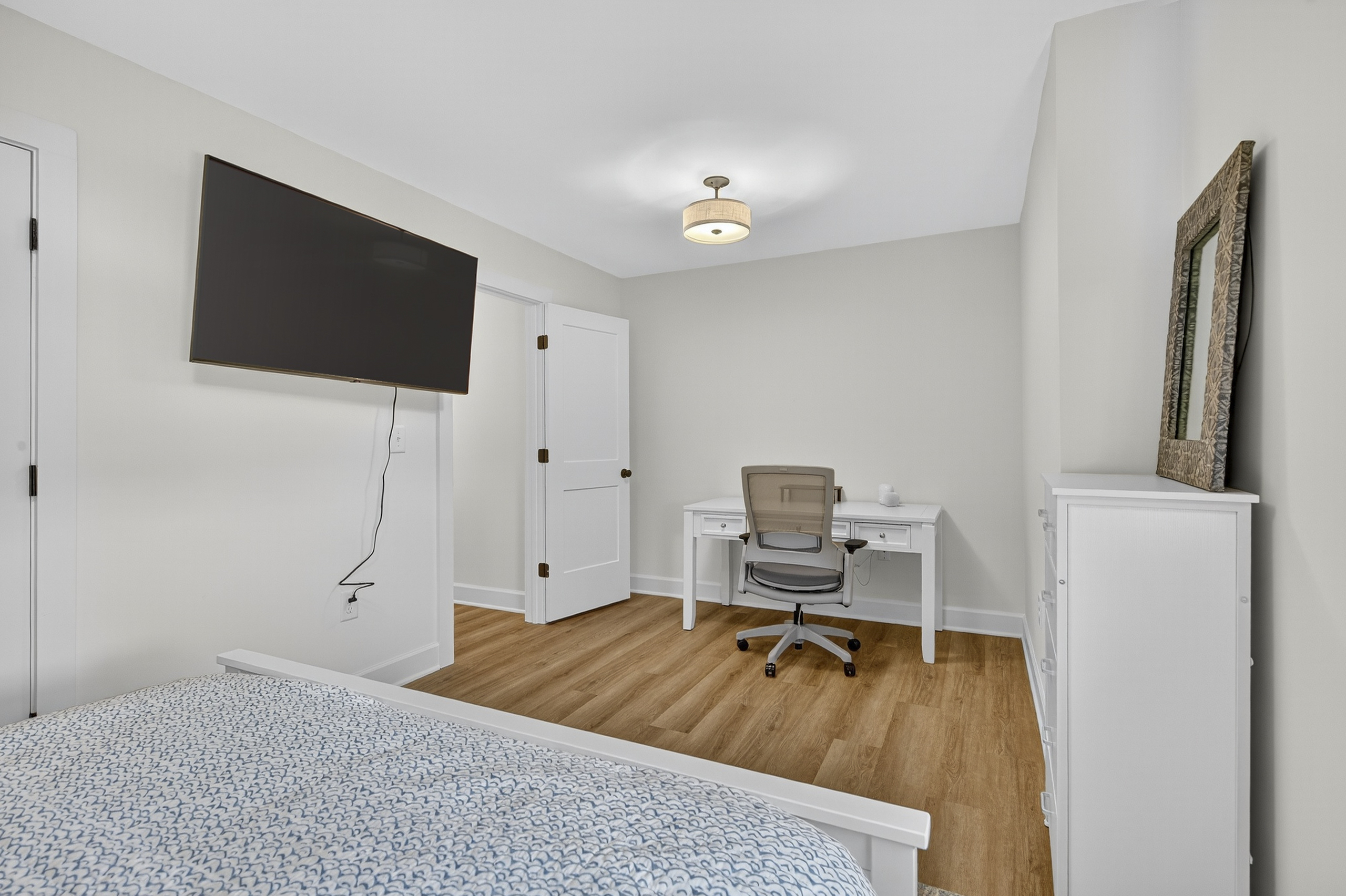 Featuring a queen bed and a work-from-home setup, this room balances comfort and productivity.