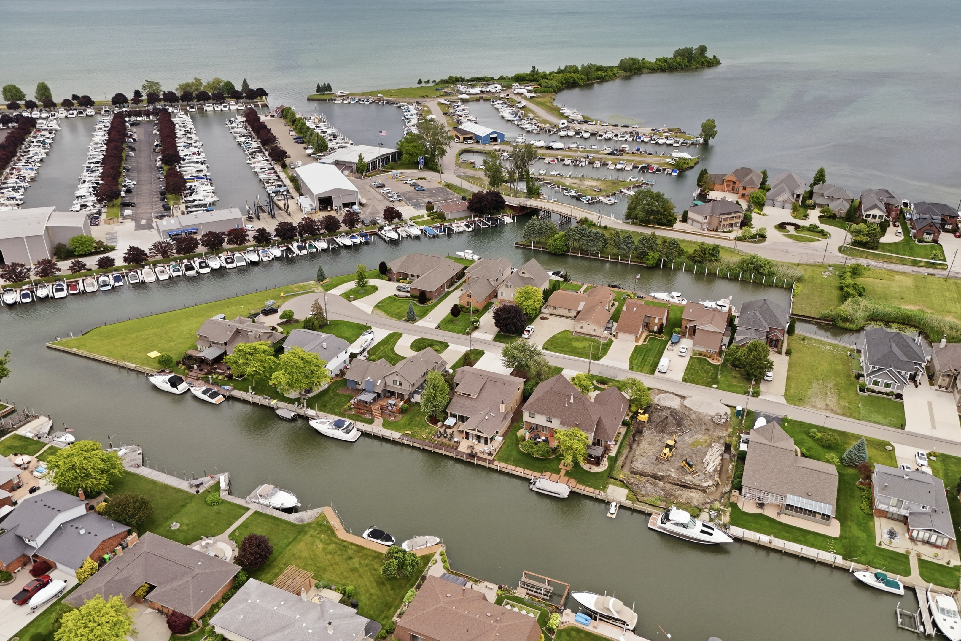 Aerial waterfront community view featuring canals, private docks, and well-maintained homes along a peaceful lakeside setting. Scenic, quiet, and ideal for a relaxing getaway with direct water access.