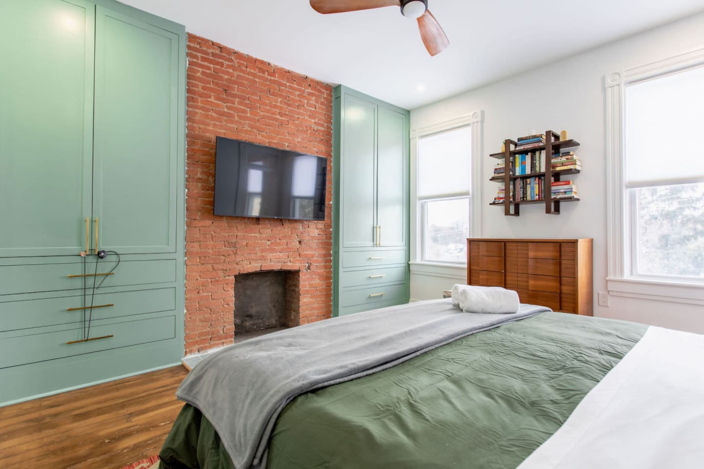 A view from the bedroom showcasing a sleek wall-mounted TV, with stylish cabinets underneath, offering both functional storage and a clean, modern look.