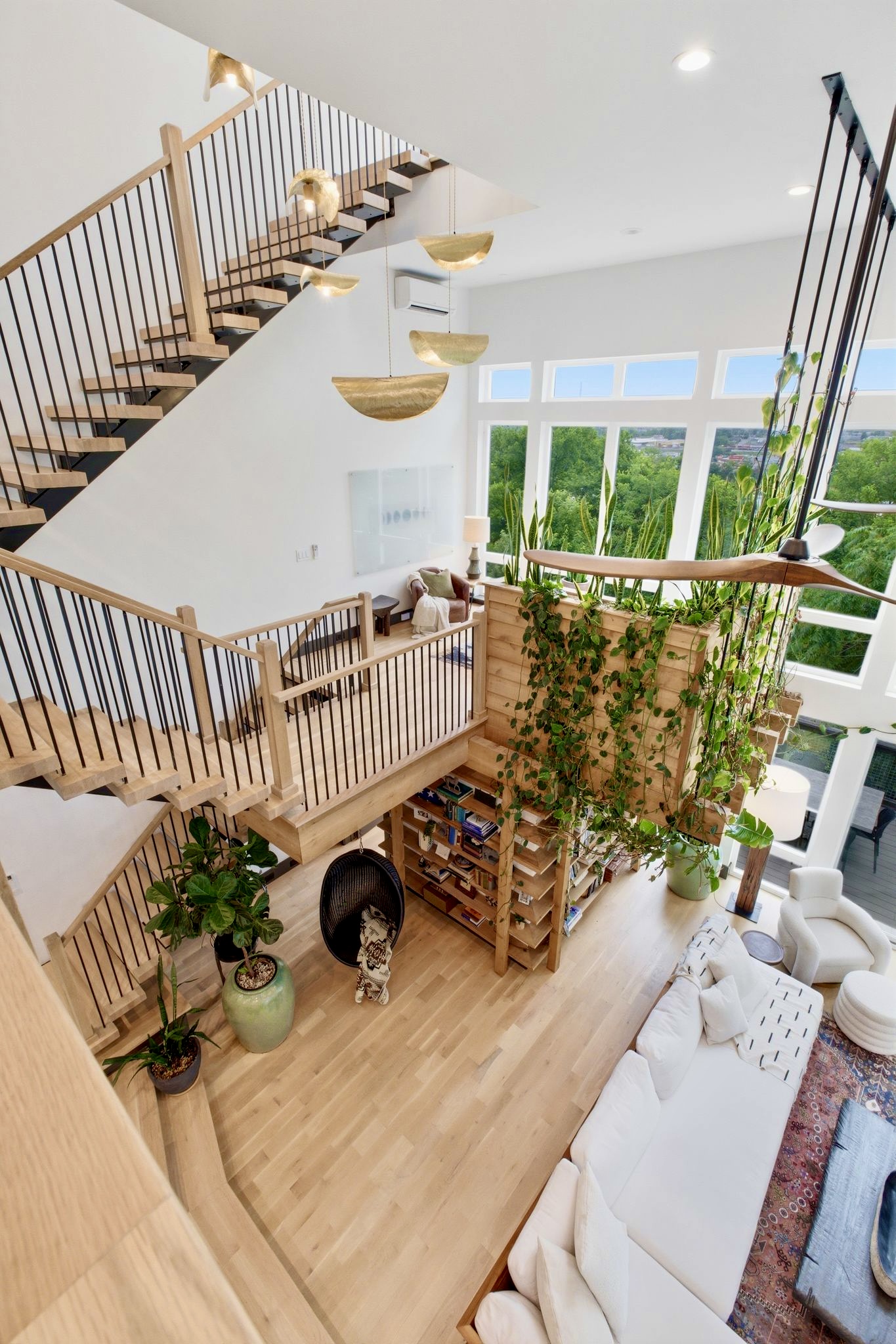 Dramatic double-height staircase wrapped in trailing vines — every inch a visual moment.
