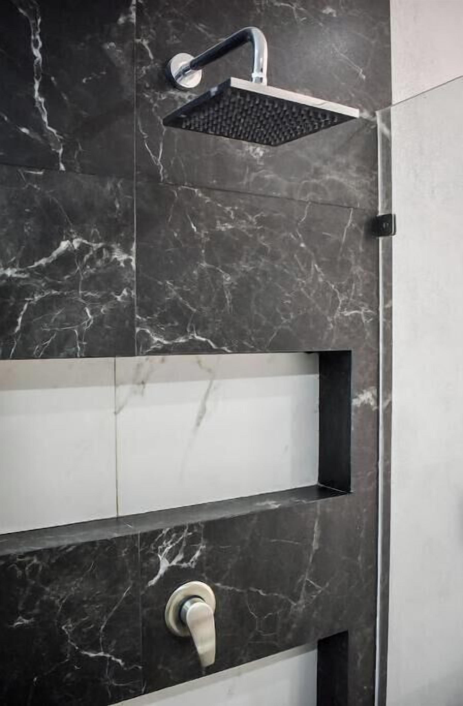 Large modern shower in both bathrooms