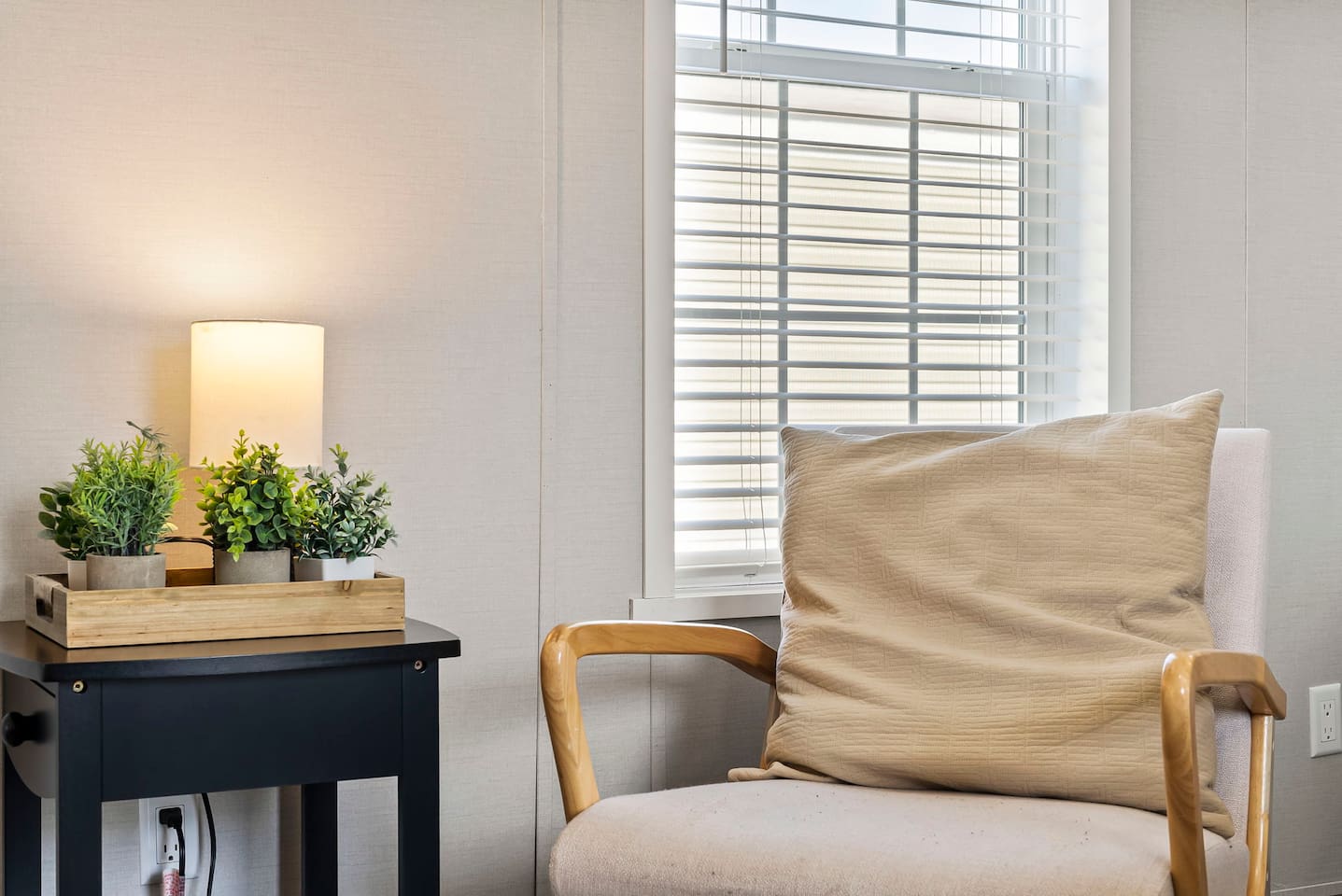 Cozy reading corner with accent chair and soft lighting—great for quiet moments and relaxation.