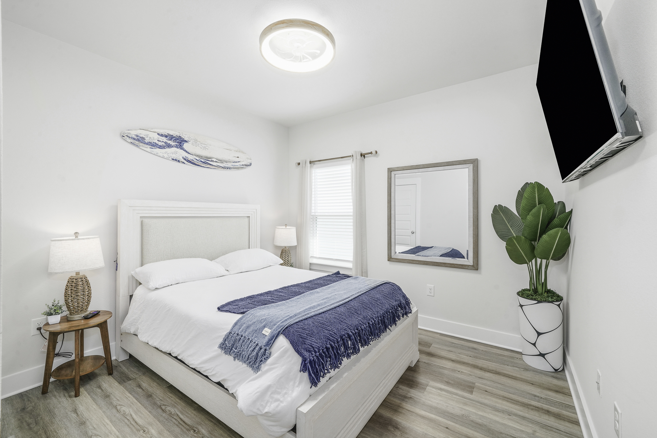 Bedroom 3: Queen bedroom, plush linens, ceiling fan, bedside lamps, wall art, and Smart TV.