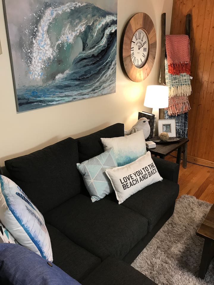 Living Room with big screen TB with view out to water.