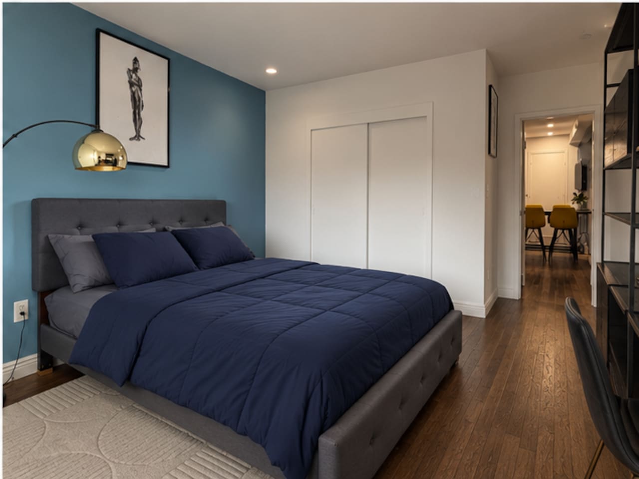 Primary bedroom with built-in closet storage — modern Little Italy NYC apartment rental"