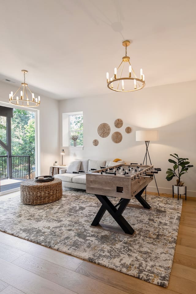 This is the game room downstairs, equipped with a 45-inch smart TV, a foosball table, and a PlayStation 5 with a selection of games.