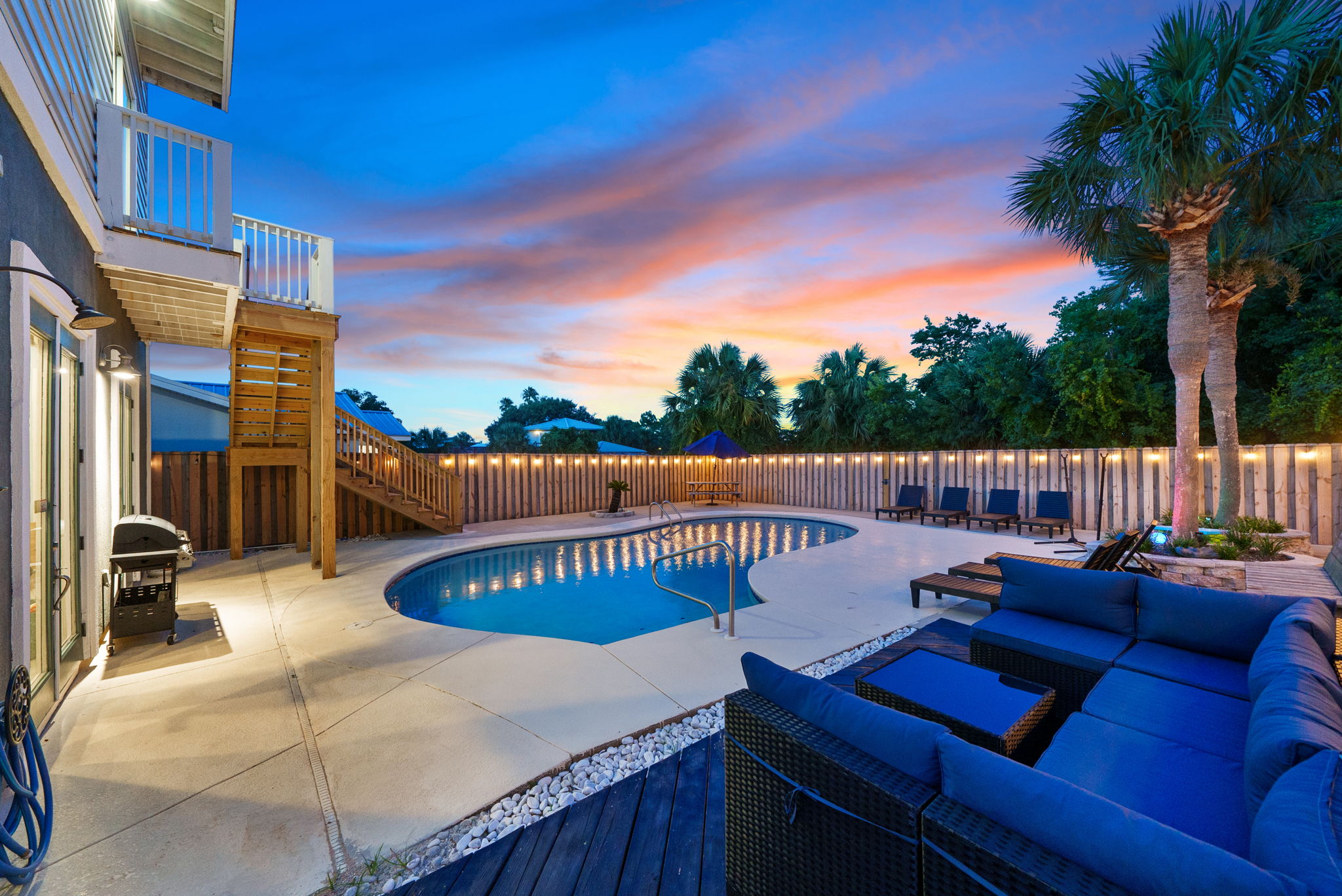 Evenings glow brighter when the pool lights up with string lights all around..