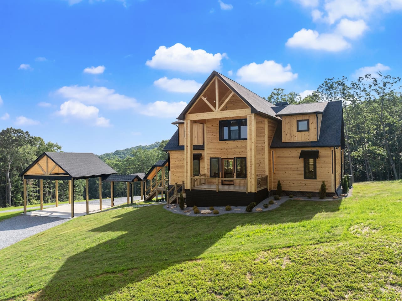 Arriving is half the experience—this front view highlights the manicured entry path, oversized porch, and dual carports ready to welcome guests.