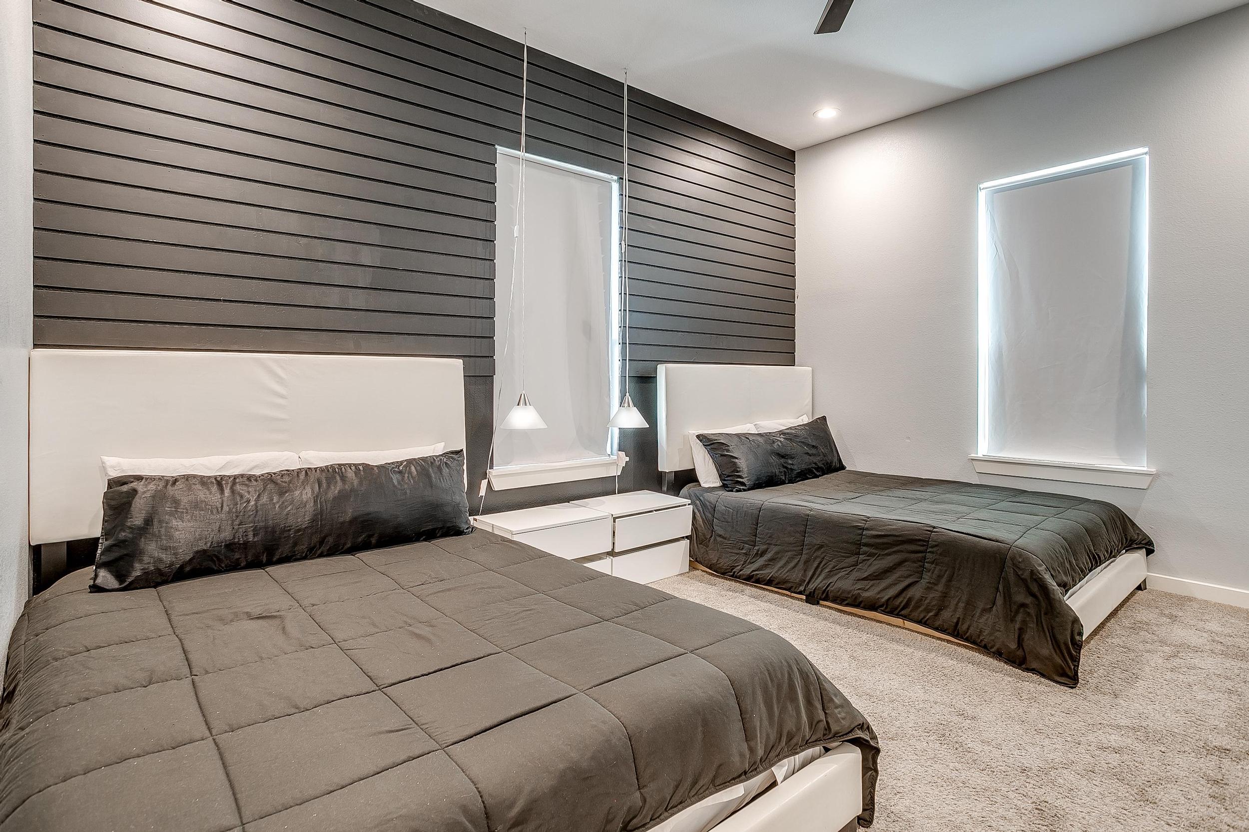 Sleek, hotel-style double queen room with blackout shades.