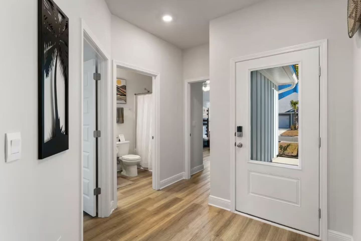 Hallway going to the bathroom, bedroom and backyard