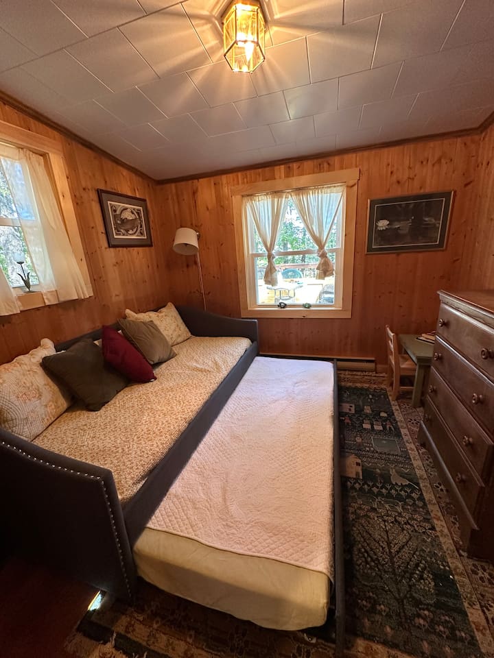 This twin bed with pull-out trundle is perfect for kids or extra guests. Bright and airy with closet storage, it’s a cozy nook for rest or quiet time.  Extra linens in closet.  Extra pillows in dresser