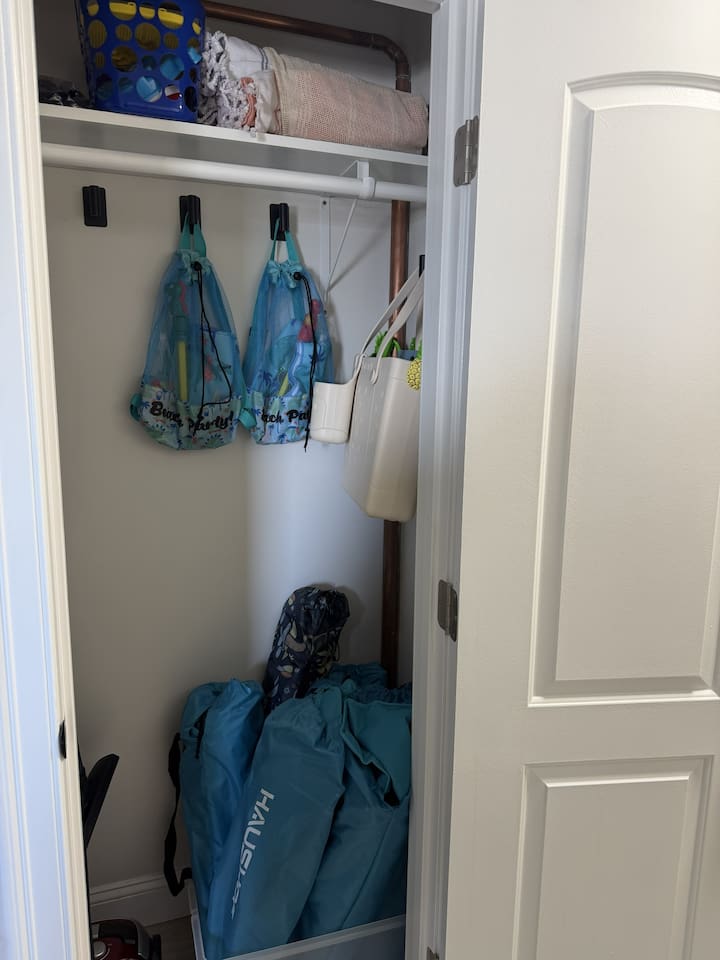 Closet with items to borrow for the Beach (towels, chairs, backpack & beach toys for kids).  Cleaning supplies.