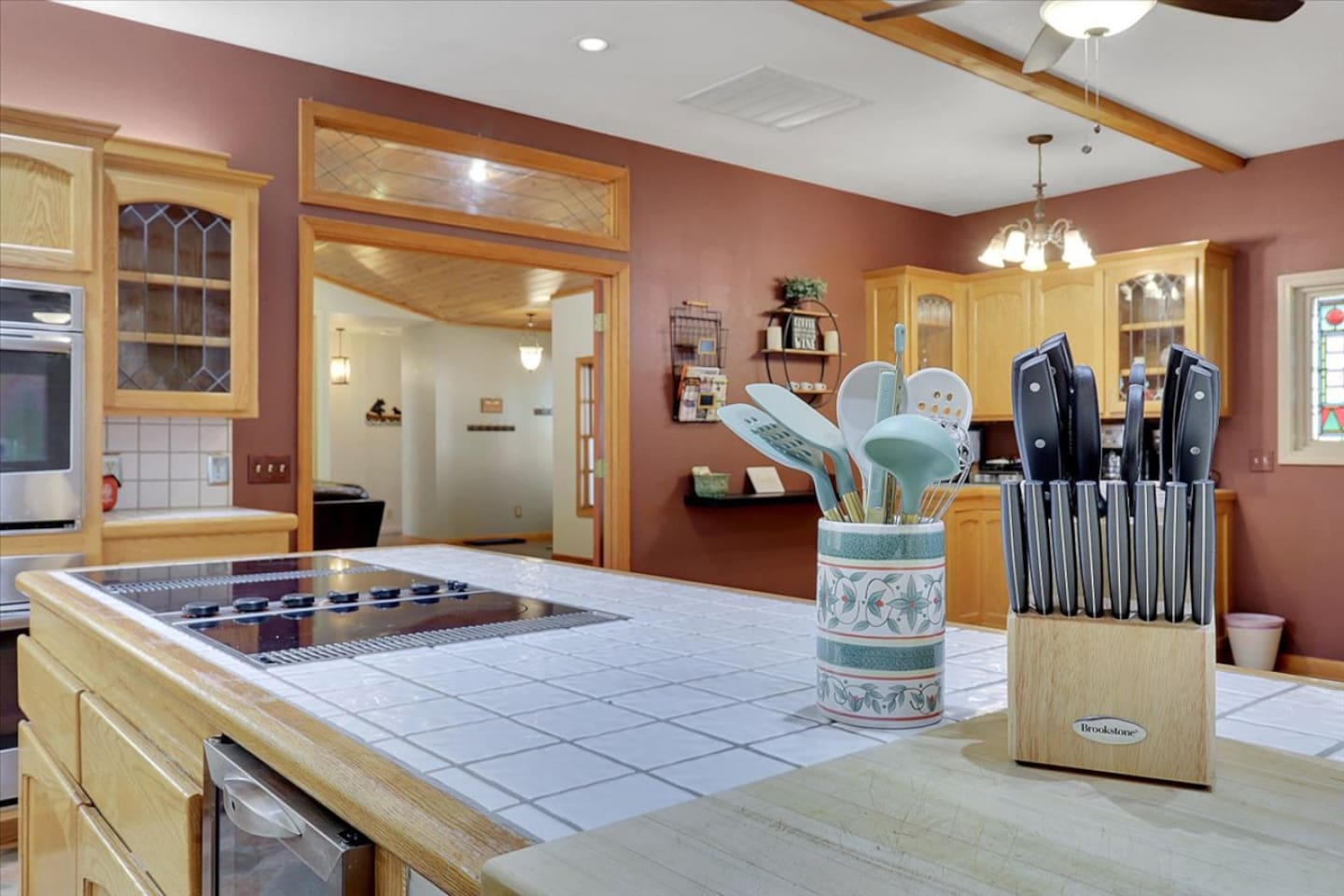 Kitchen island with cooktop, knife set, and easy access to the dining area.
