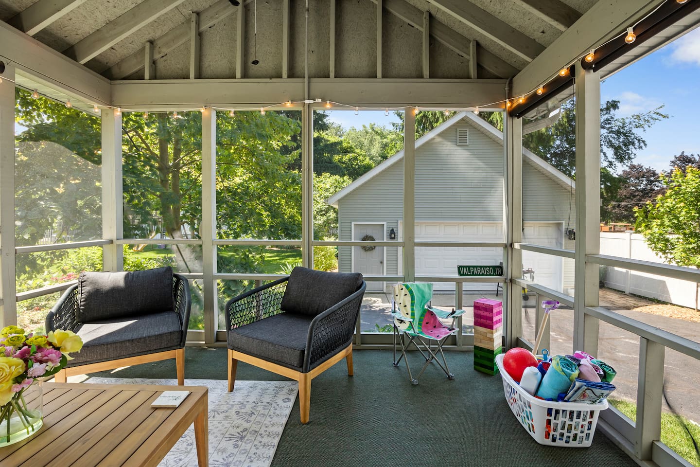 Screened-in porch located just off the dining room. Kid's chair, life-size Jenga and beach necessities available.