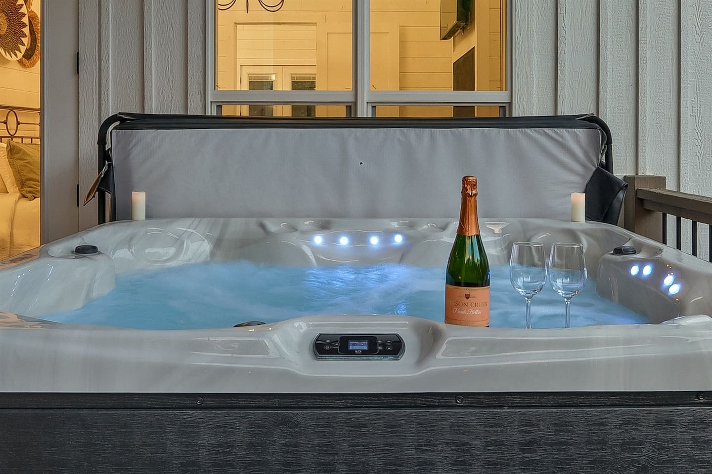 Soak under the stars in your private hot tub, surrounded by string lights and peaceful forest views.