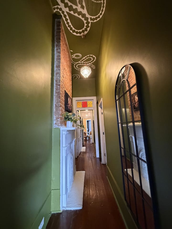 Original hardwood floors, a full-length mirror, serpents curling across the ceiling, and art that makes you look twice. La Lune Noire doesn't wait to cast its spell.