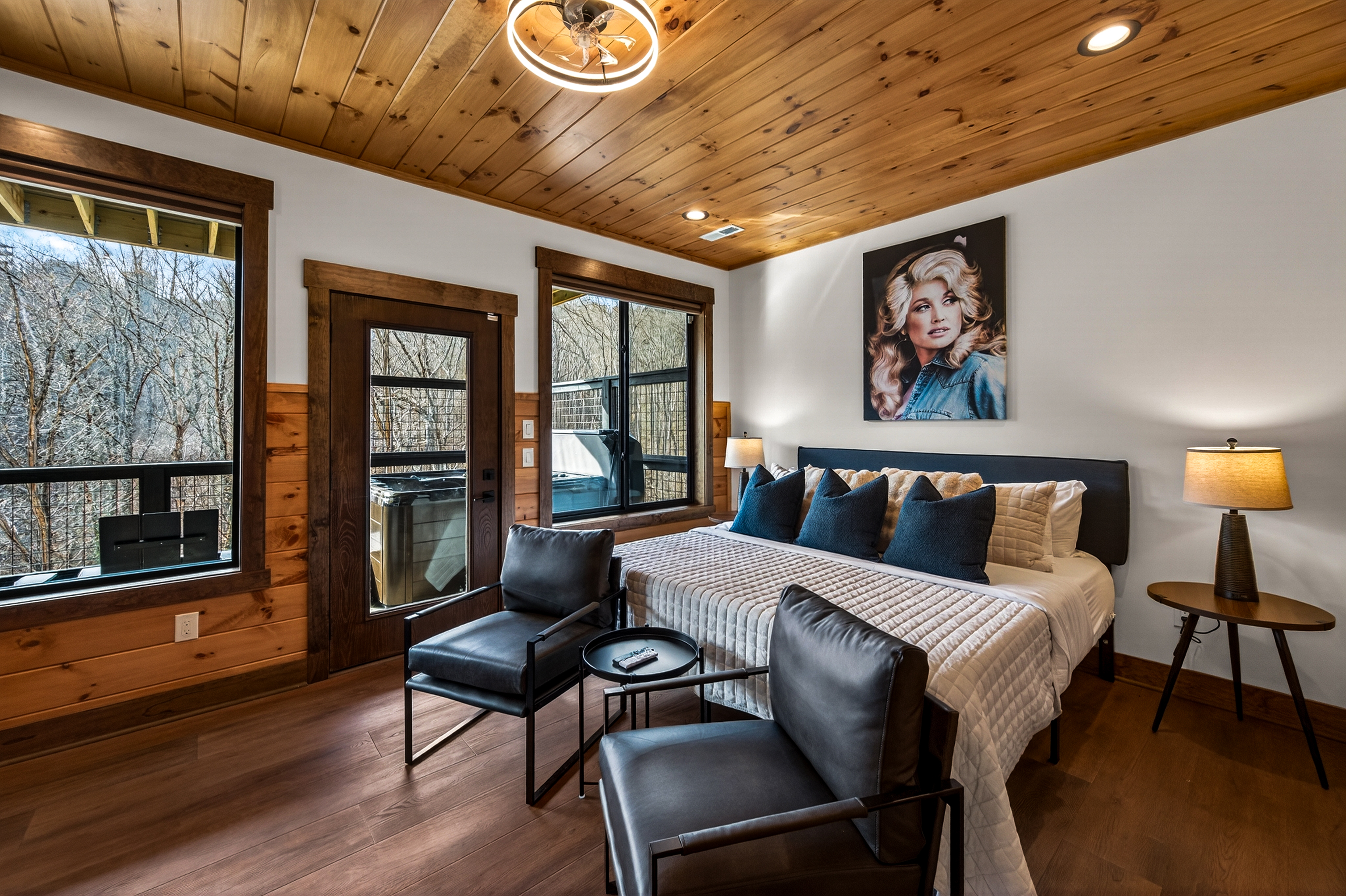 Relax in the spacious king bedroom on the game room level with a big TV, desk & direct deck hot tub access. Unwind in the en-suite bathroom featuring a walk-in shower with a natural river rock floor, bringing  the Smoky Mountains indoors for a spa retreat.