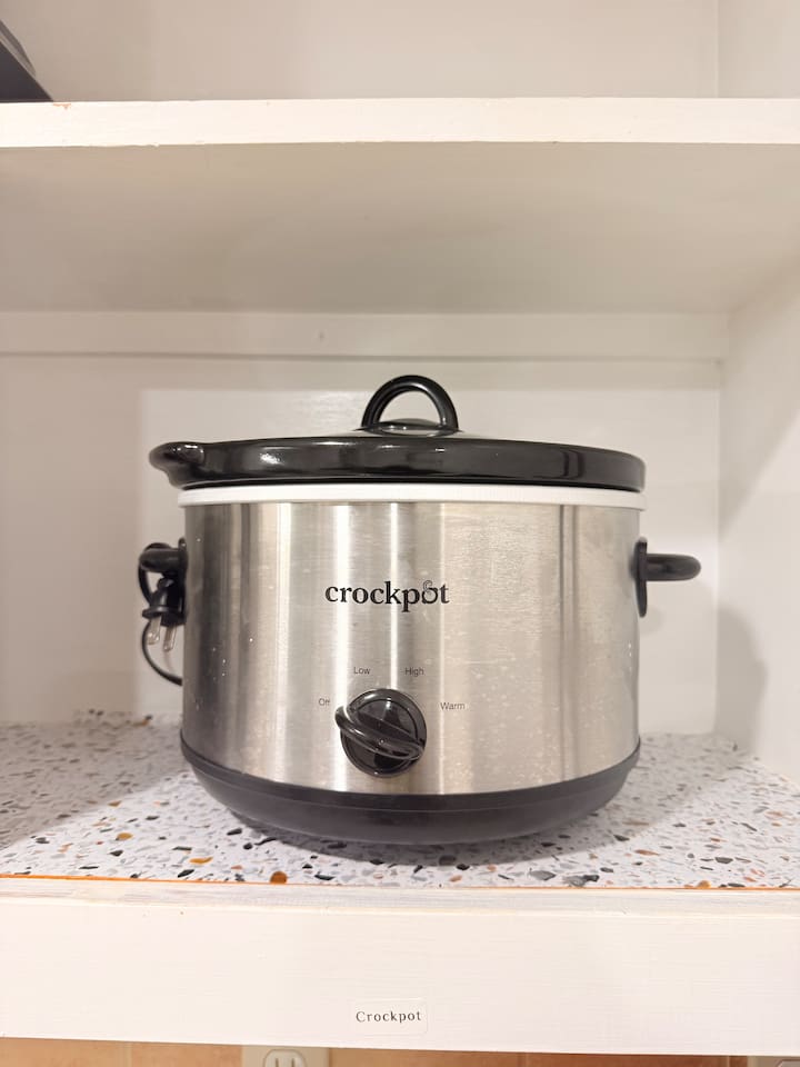 A fully stocked kitchen includes convenient tools like a Crockpot — great for easy meals after busy days.