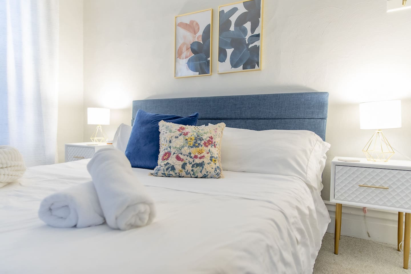 Discover the King Bedroom, a spacious room on the second floor with king bed flanked by nightstands with lamps.