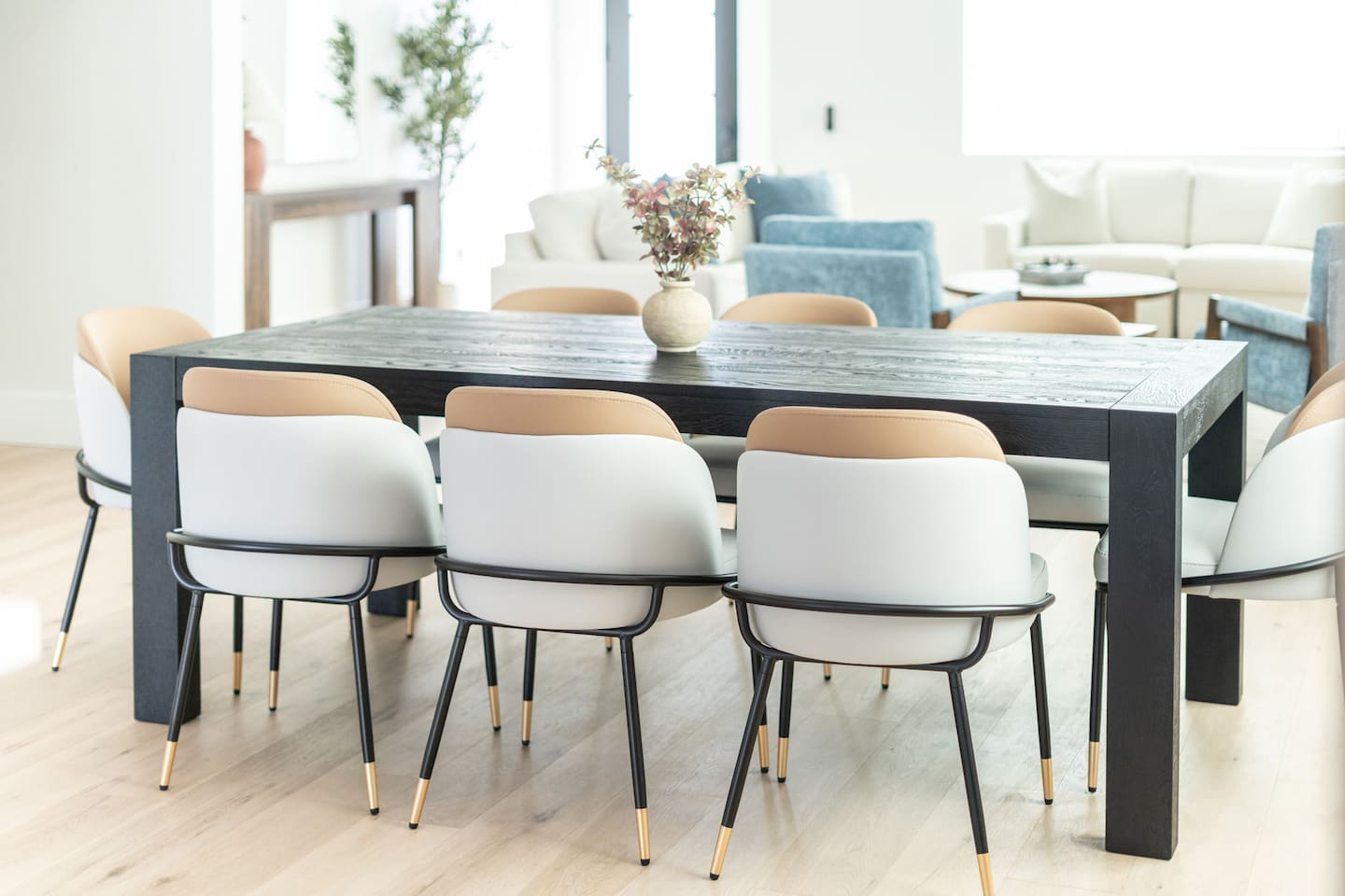 The rich wood grain table and chic centerpiece set a refined tone for memorable meals.