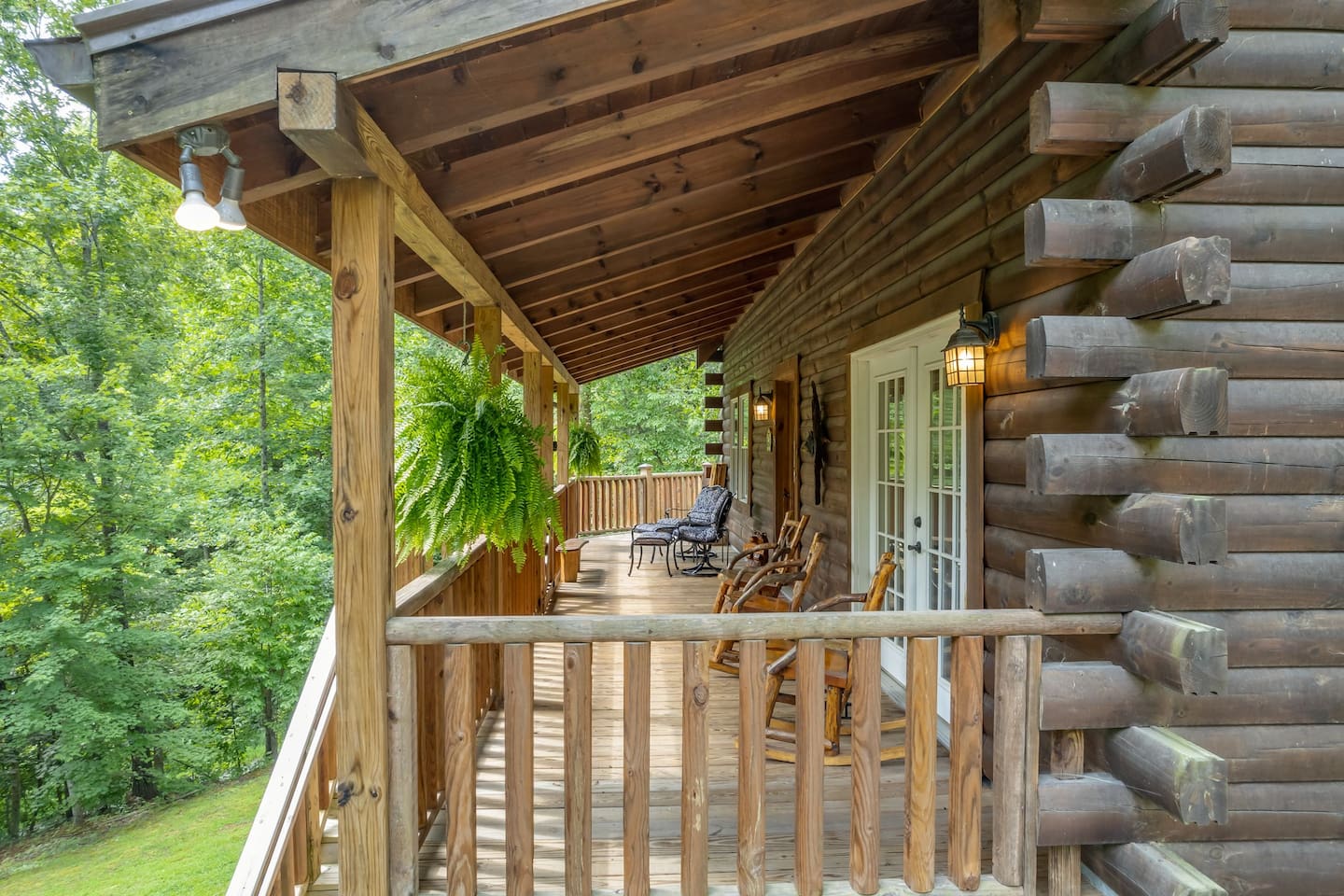 Large, fully enclosed, ( great for little ones and pups) wrap around porch with seating, large log picnic table and corn hole game