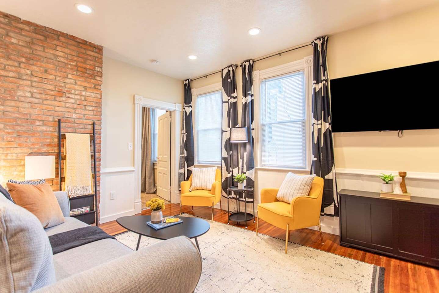 Living area featuring a comfortable couch, a stylish center table, and tasteful wall décor, creating a cozy and aesthetically pleasing space to relax and unwind.