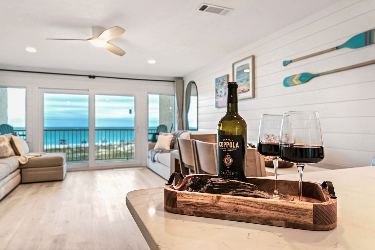 Evenings at El Secreto Azul hit differently — marble countertops, coastal shiplap interiors, and unobstructed Gulf views glowing through the floor-to-ceiling doors. Destin Beach luxury from every angle.