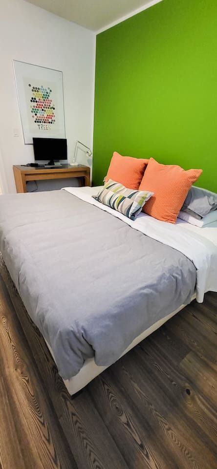 King sized bed with a desk and computer monitor with HDMI connector