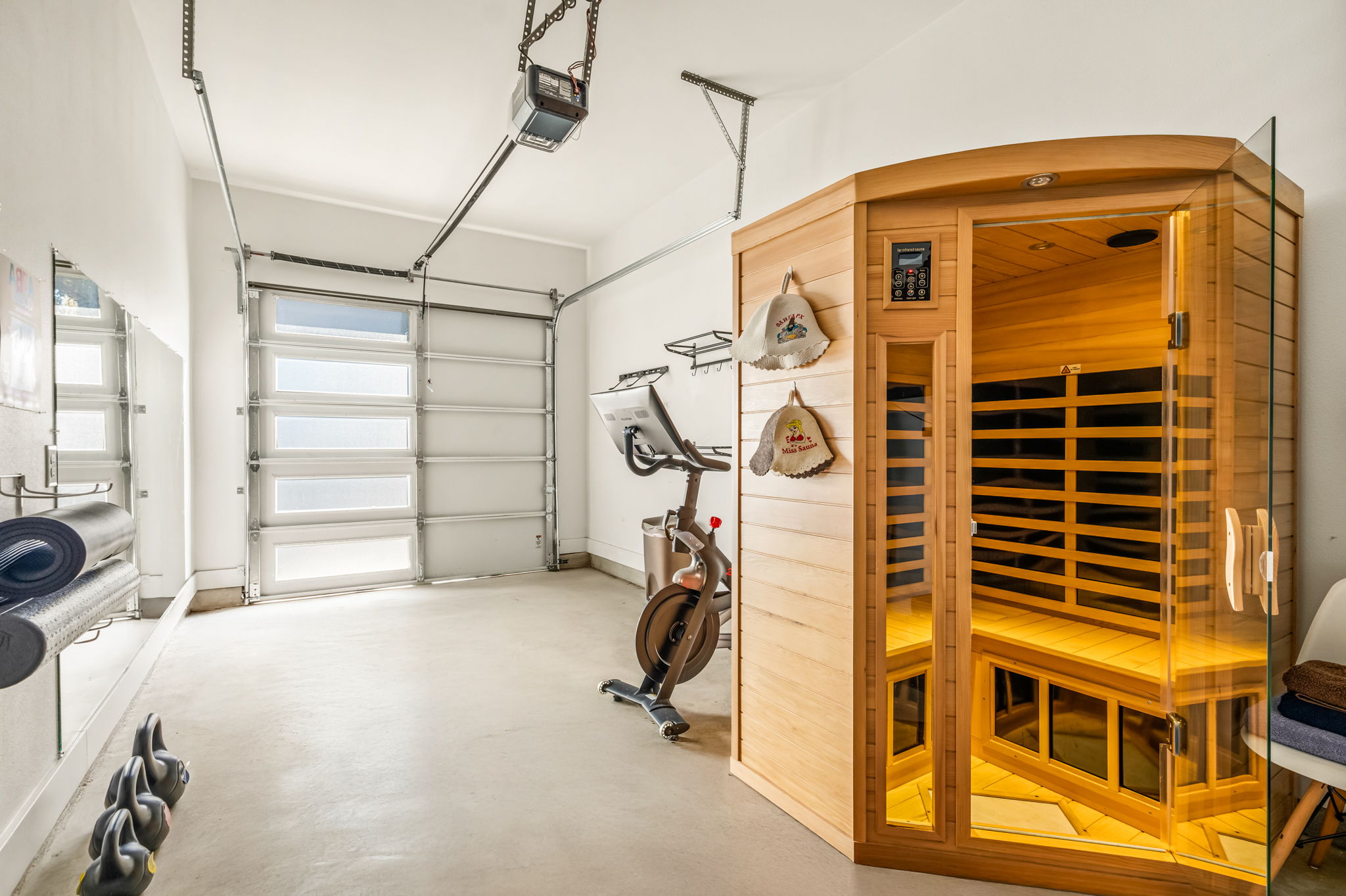 Spacious gym area featuring an infrared sauna and fitness equipment