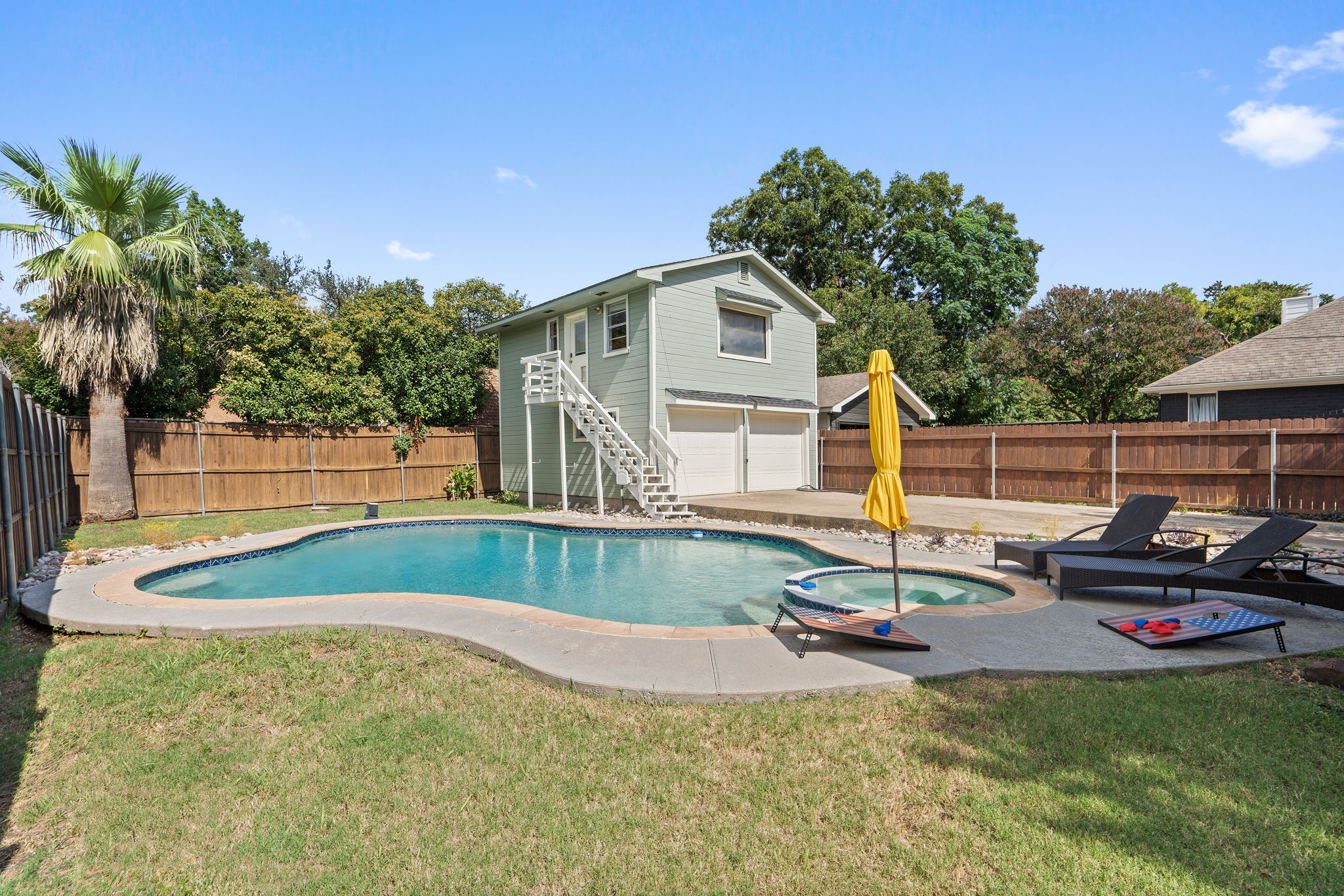 Private unheated Pool with sun loungers, patio seating, and fully fenced backyard. Outdoor furniture and umbrella included. Shared between main house and Detached Studio guests. Dallas, TX.