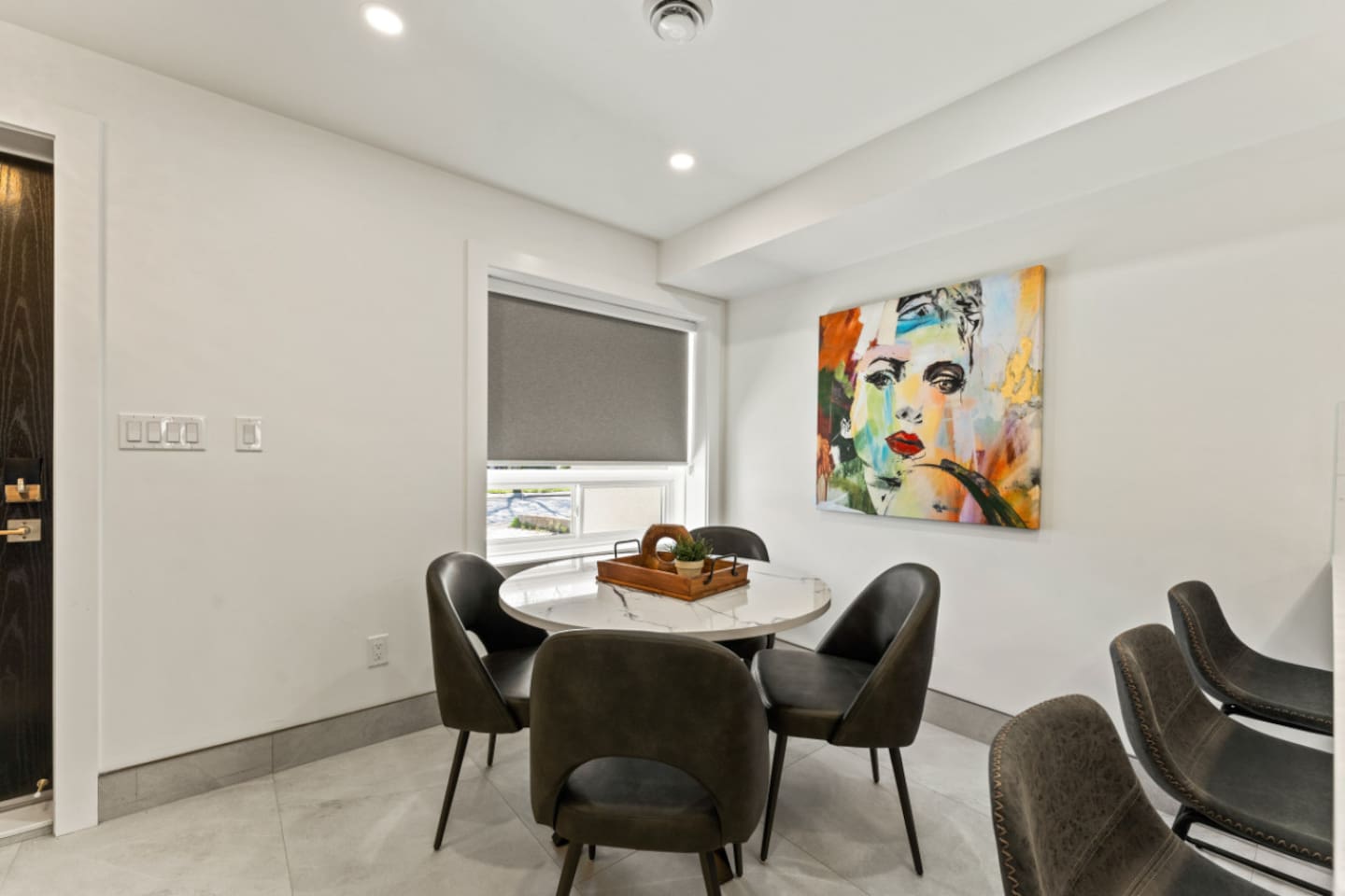 A sleek dining room, with an open kitchen concept for the best dinners.