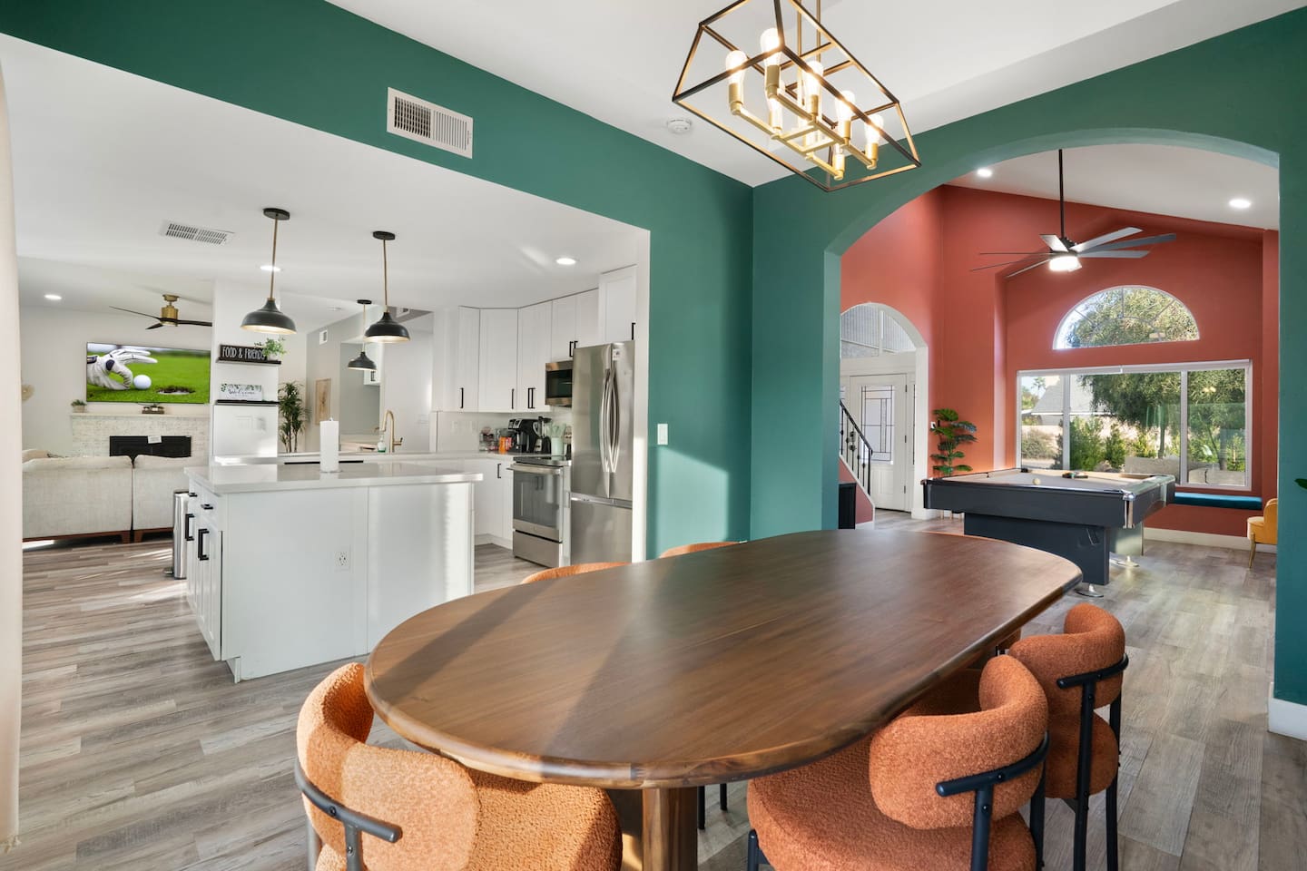 Expansive open layout with colorful accent walls, chef's kitchen, game room, and multiple living zones.