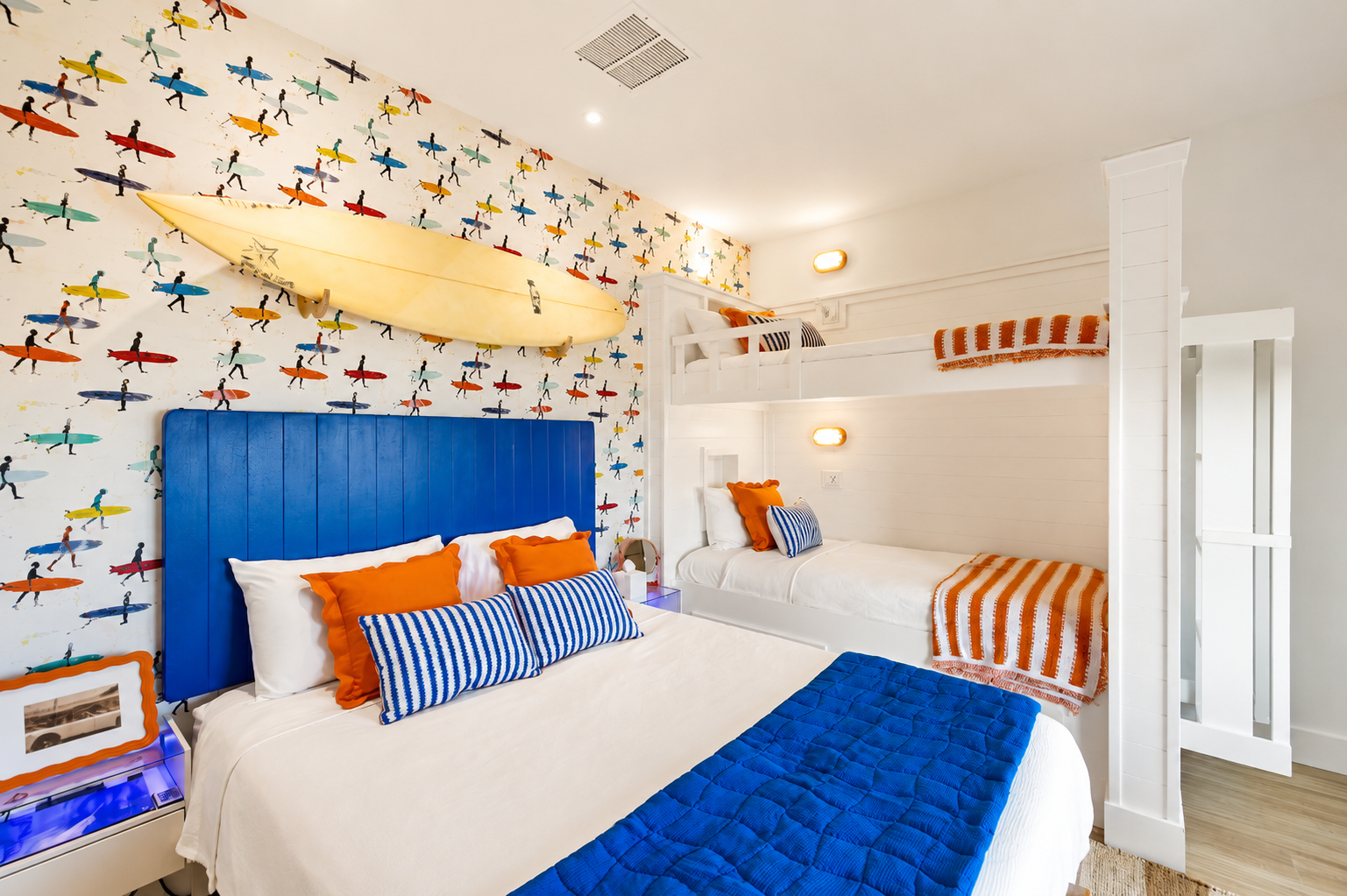 The Sunrise Surf Shop themed Bedroom includes spacious bunk beds, a comfortable queen bed, beautiful views and nearby access to the second floor balcony. Guests will utilize the half bath on the main floor and shower in another guest suite.