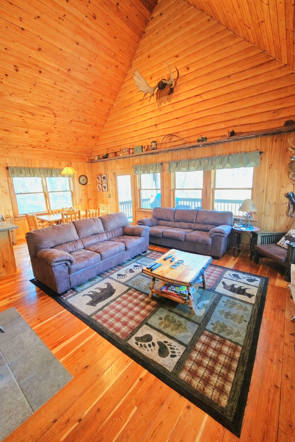Comfortable living room after a full day. Coffee table has been updated to an ottoman. One of the sofas has a pull-out beds. Another sofa bed is downstairs.