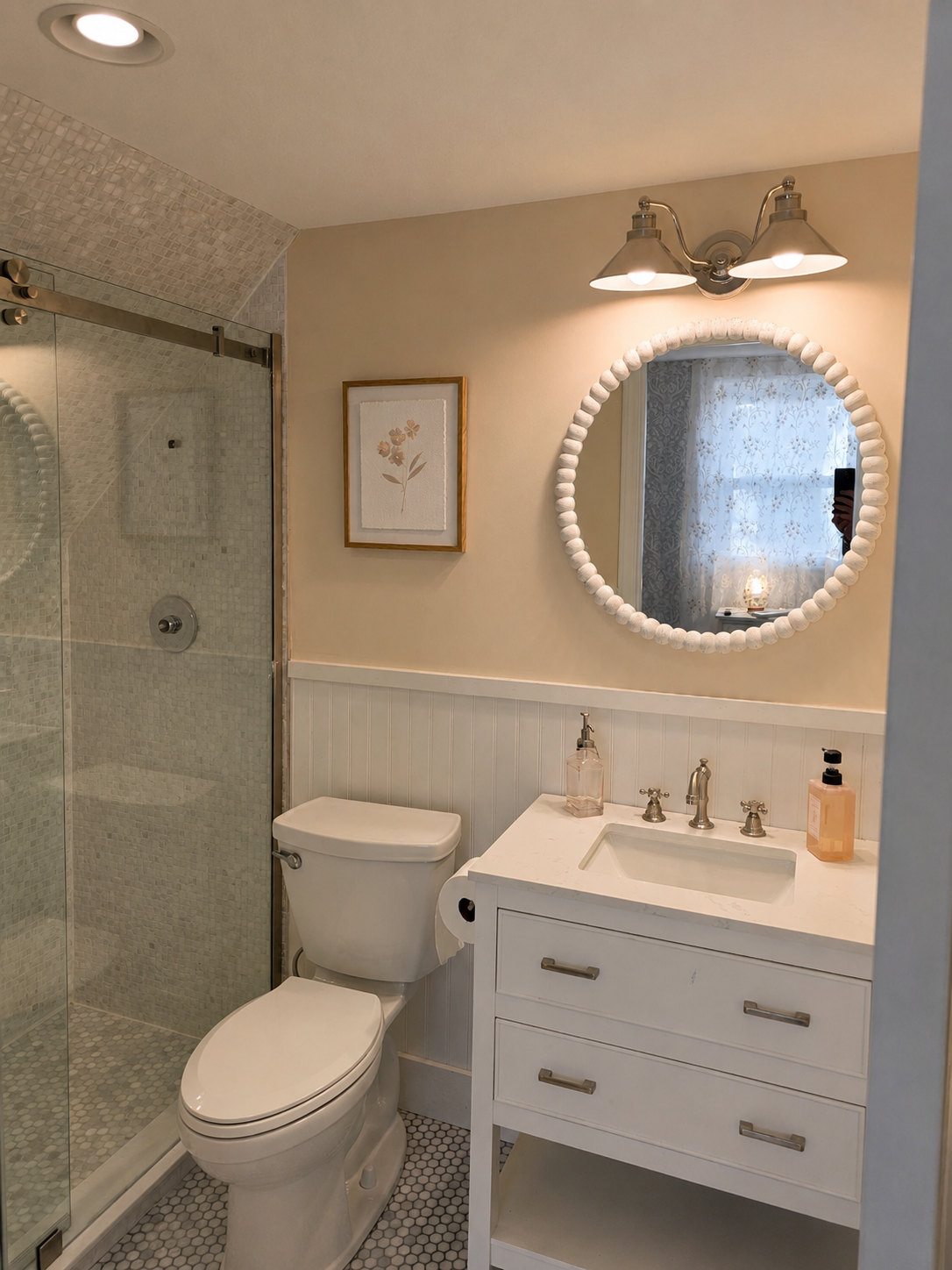 Second-floor primary bathroom with a walk-in shower, vanity area and bright mirror lighting.