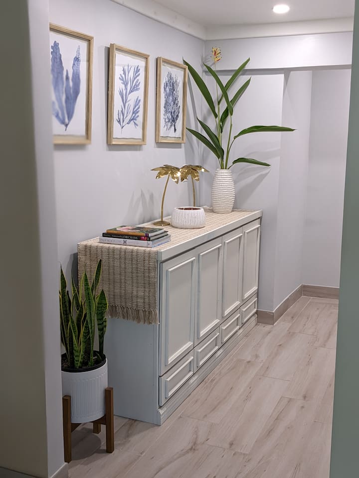 This is the hallway leading into the primary bedroom. Inside the cabinet there are extra super plush towels and linens. 