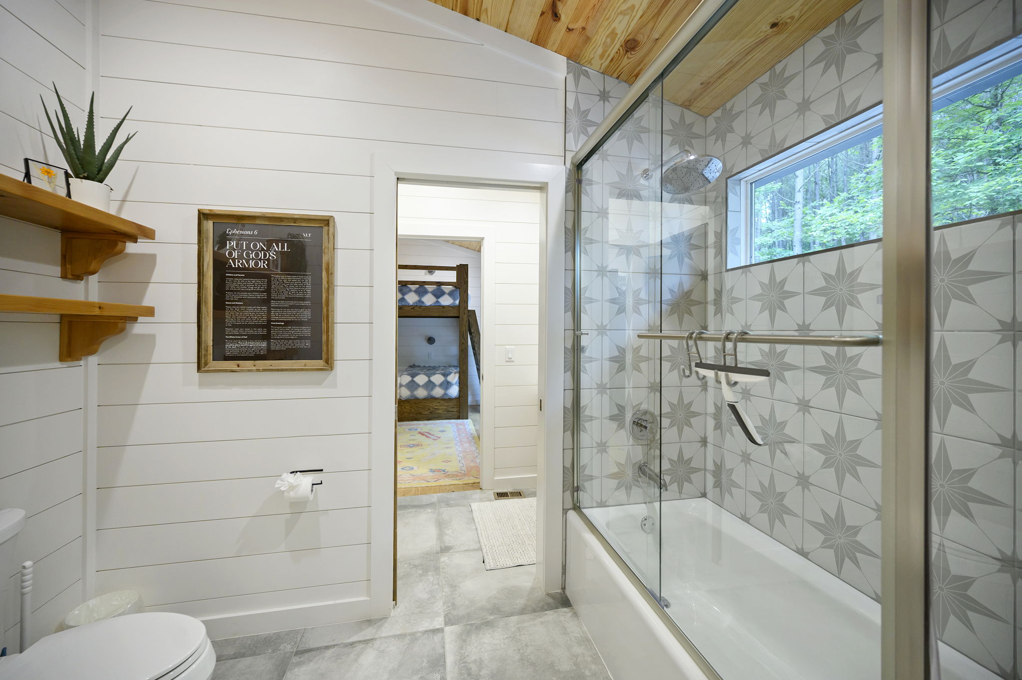 The shared full bathroom offers a cozy, spa-like feel with luxury finishes, warm design details, and everything guests need to feel comfortable and refreshed.