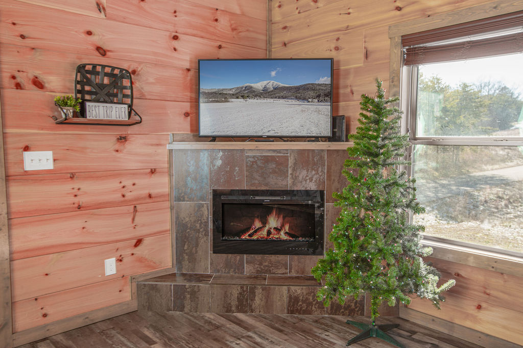 Relax by the fire with beautiful holiday decorations.