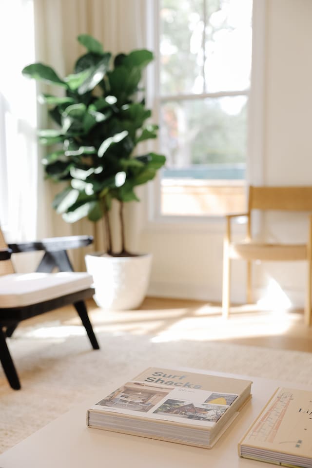 The light-filled living room features an oversized Floyd couch, a 70" smart TV and an open floor plan that flows seamlessly into the kitchen and dining areas. Great spot for hanging with a large group.